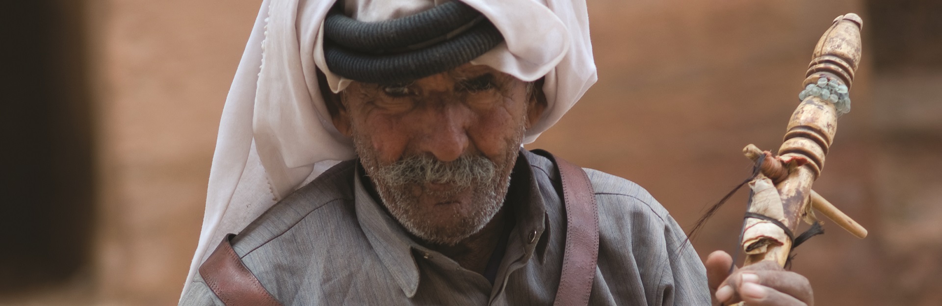 Bedouin man playing traditional instrument
